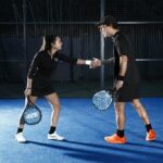 Man and woman playing Padel and having a funny moment