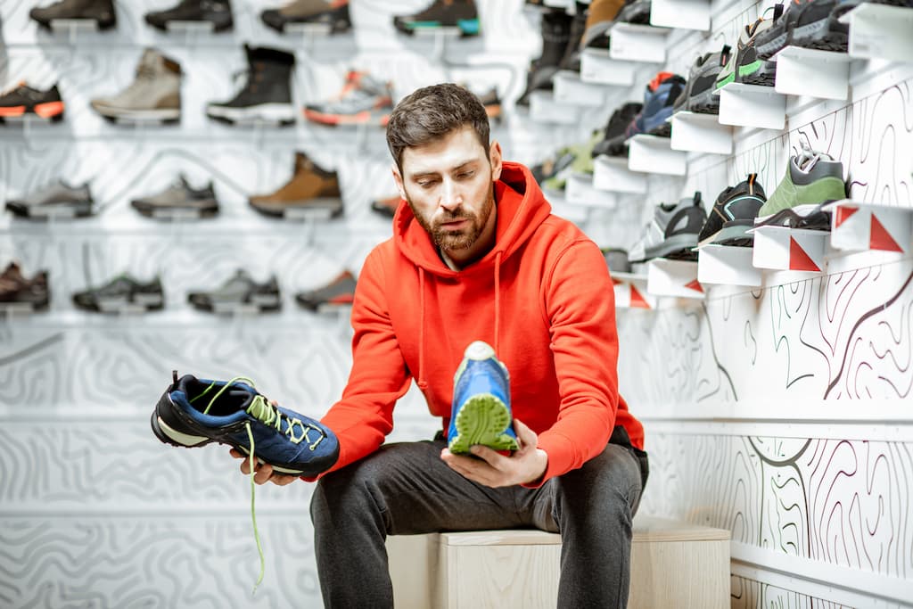 Man holding shoes in the store