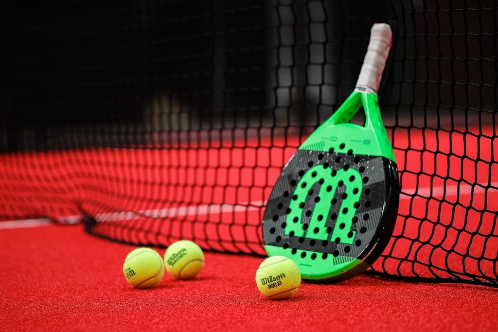 Padel racket and Padel balls on the court