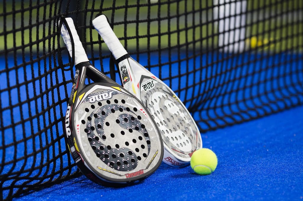 Padel rackets on the Padel court leaned to the net