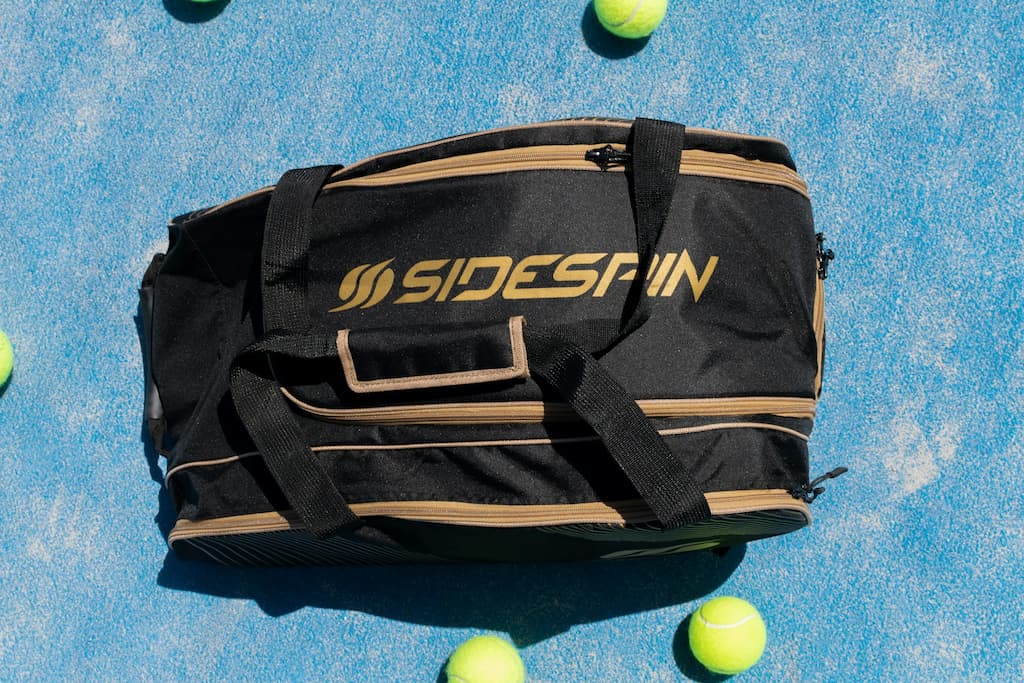Racket bag on Padel court next to the Padel balls