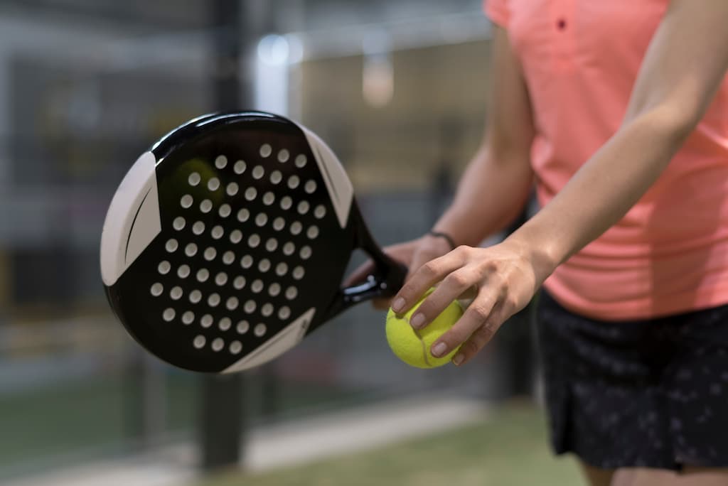 Woman holding Padel racket and Padel ball